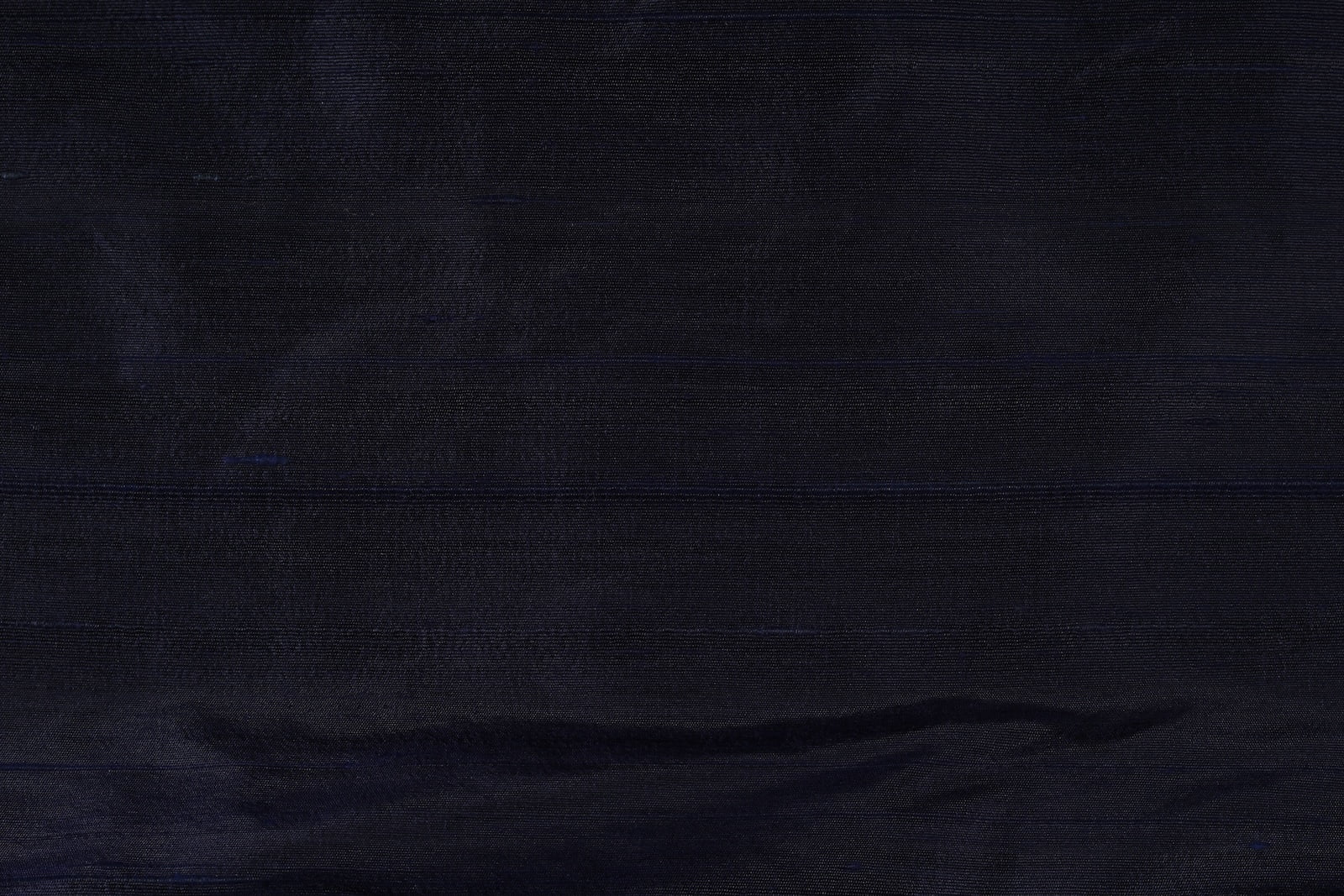 Close-up of Deep Navy Dupion Silk Fabric showing natural slub texture, woven silk detail, and subtle tonal variation
