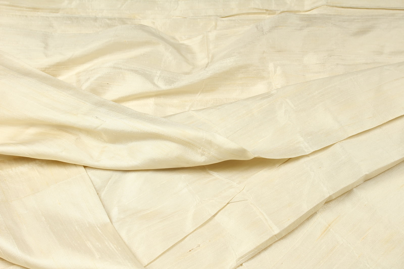 Ivory Dupion Silk Fabric displayed with soft folds revealing natural silk texture, subtle sheen, and sophisticated ivory tones