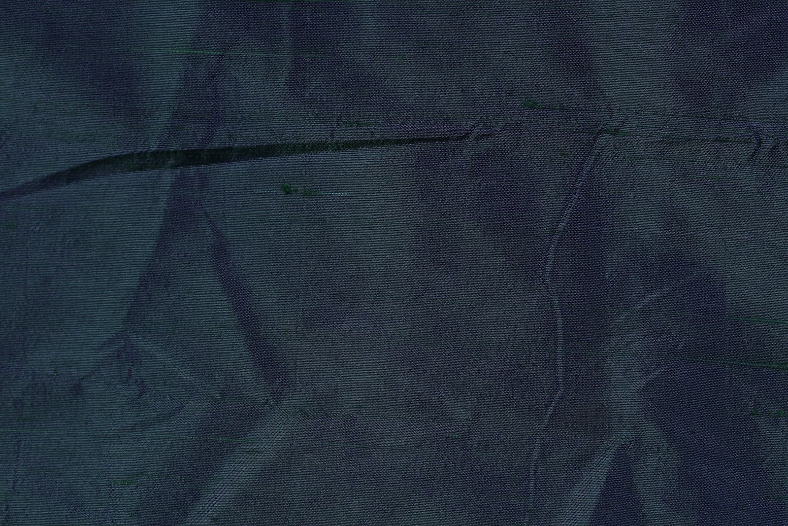 Close-up of Peacock Blue Dupion Silk Fabric showing natural slub texture, iridescent colour variation, and woven silk detail
