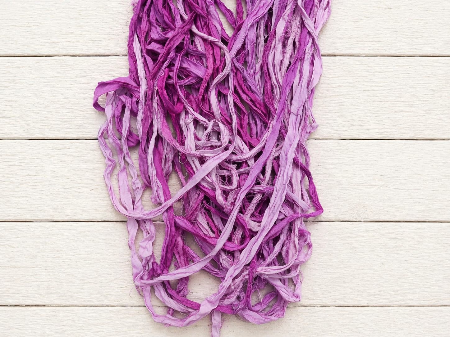 Close up texture of orchid pink sari silk ribbon strands
