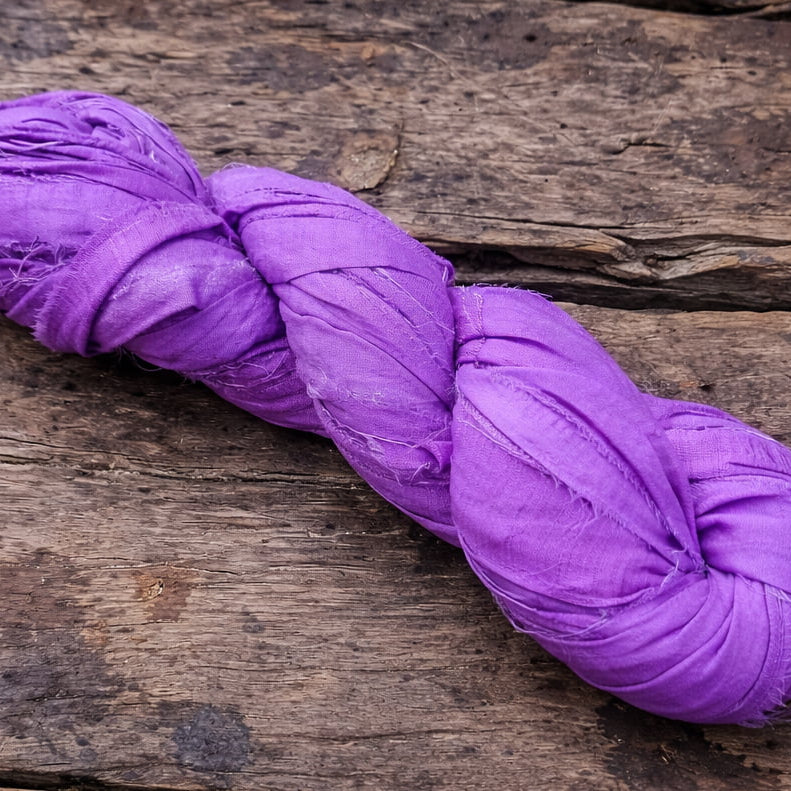 Single violet sari silk ribbon skein in a vibrant purple shade.