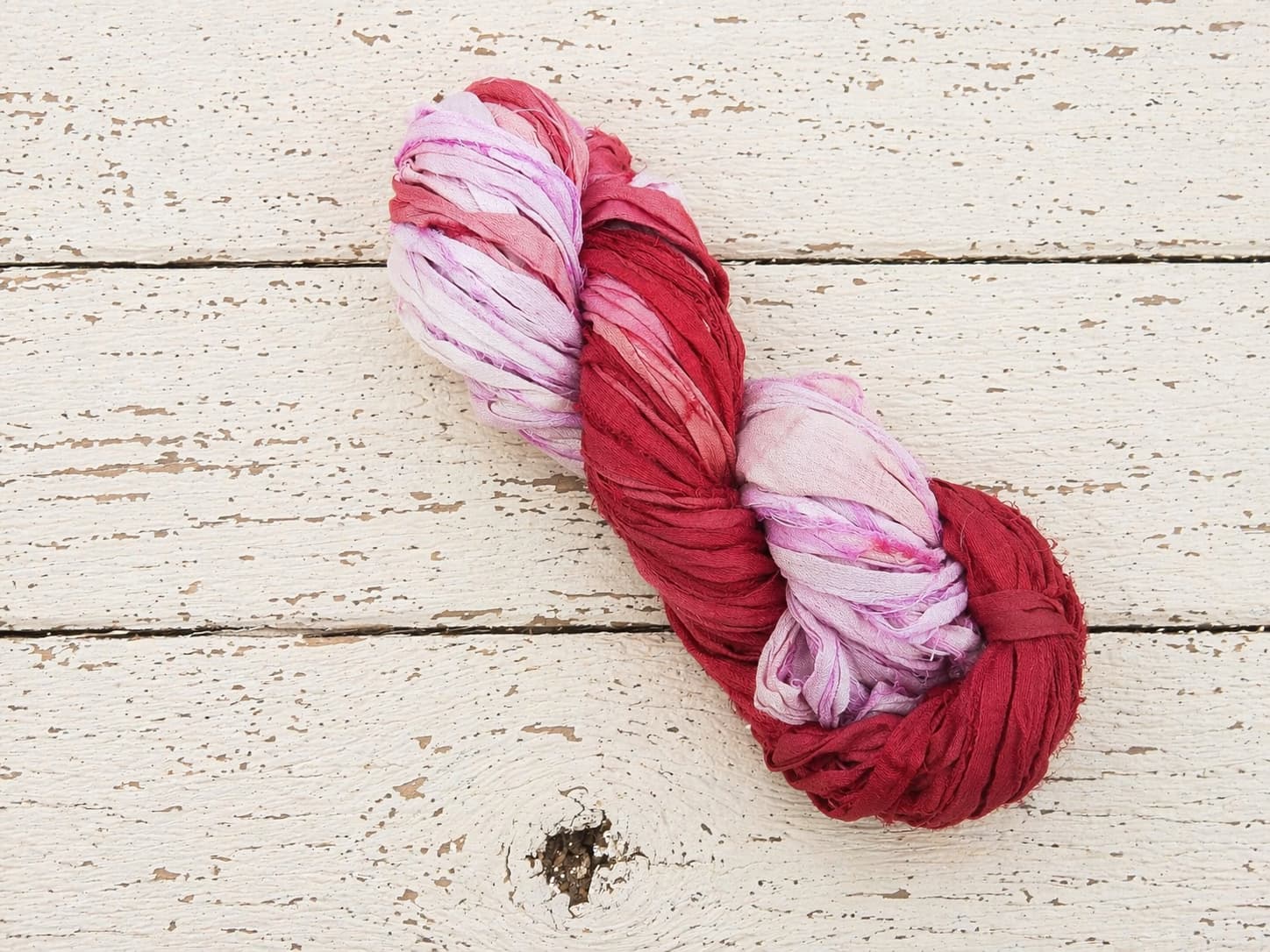 Single skein of Berry Blossom recycled sari silk ribbon yarn
