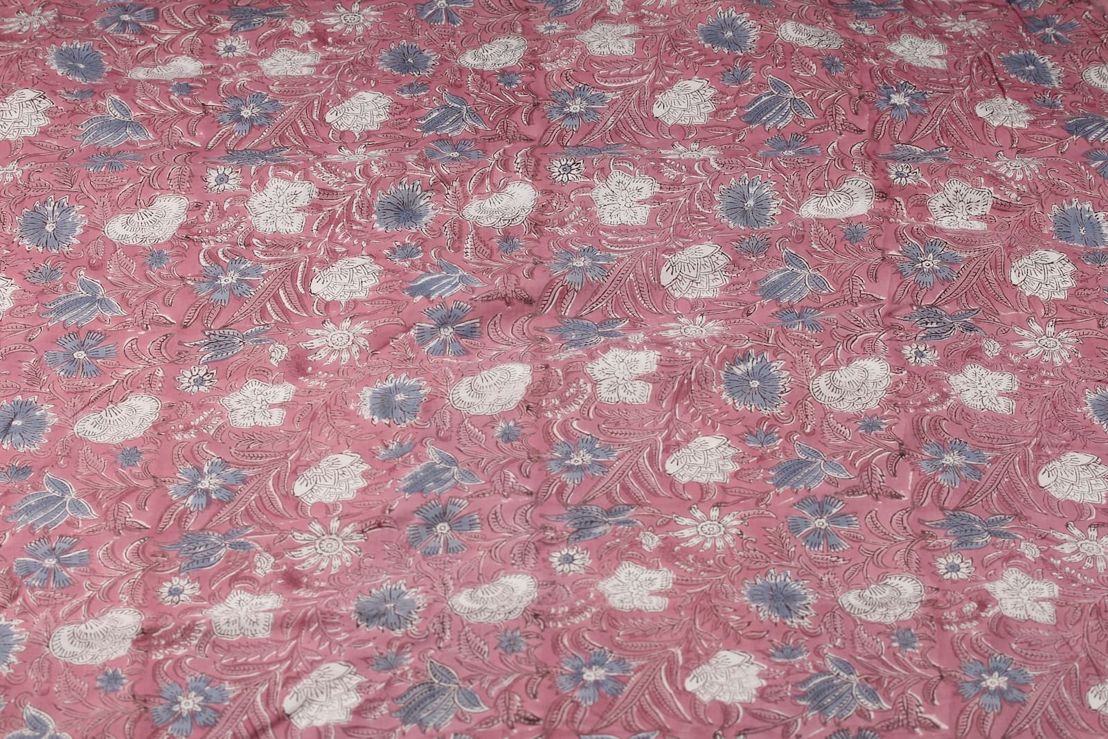 Rosewood Meadow block print cotton fabric featuring ivory and dusty blue wildflowers on a rose pink background