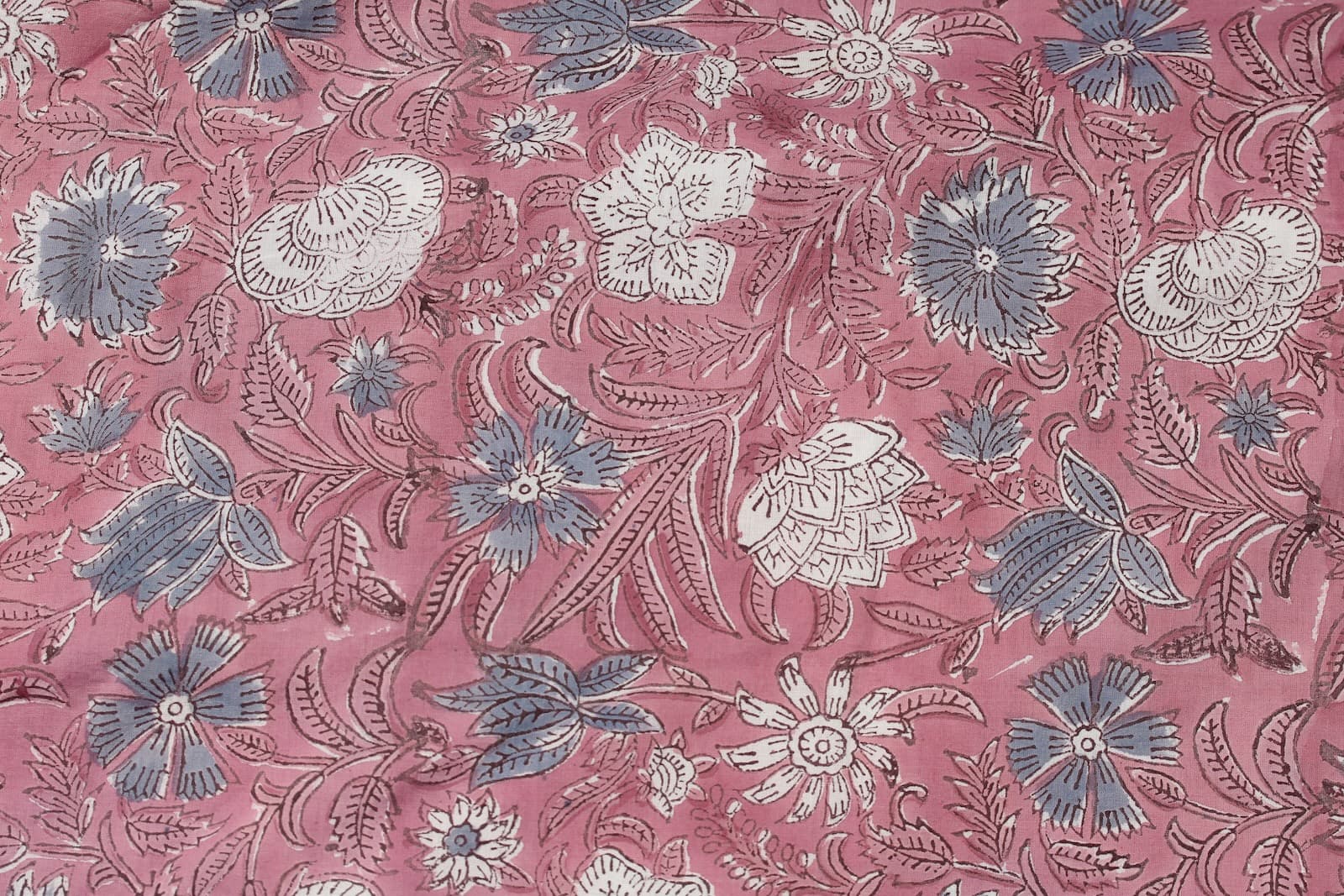 Close-up of Rosewood Meadow floral block print cotton fabric with hand printed wildflower motifs