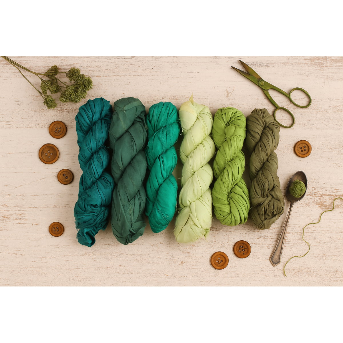 Assorted green shades of sari silk ribbon flat lay – avocado, olive, pine, and spring tones, recycled silk 50g skeins