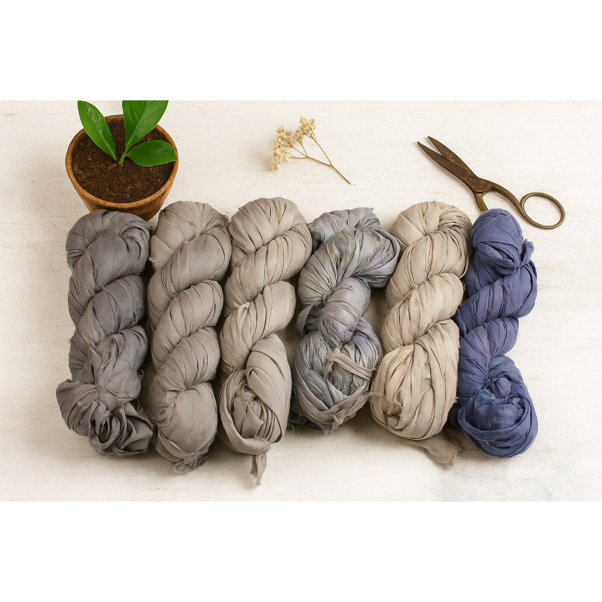 Assorted grey and blue shades of sari silk ribbon displayed together – handmade recycled silk ribbon collection