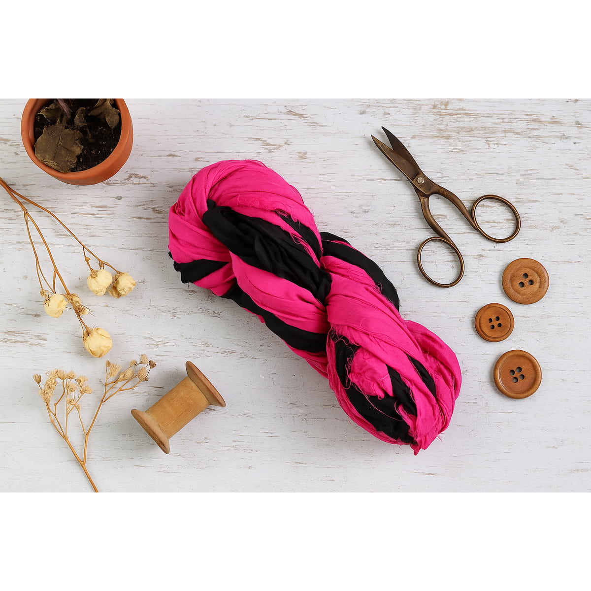 Flat lay of pop pink and black sari silk ribbon for jewelry making, sewing, and DIY projects