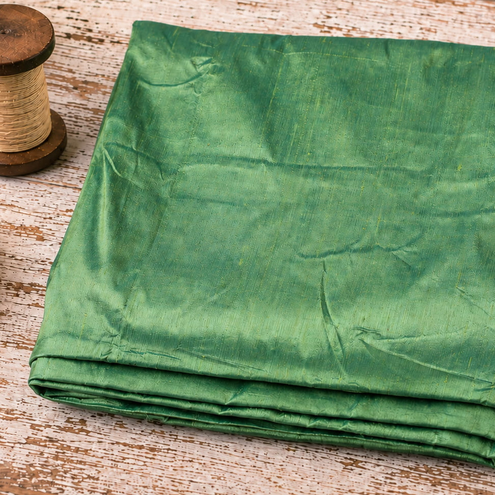 Seafoam Green Dupion Silk Fabric folded to showcase its soft seafoam green colour, natural silk texture, and elegant sheen