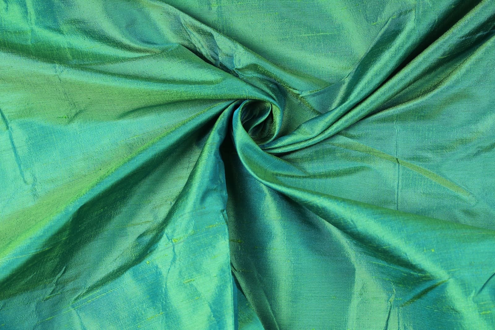 Seafoam Green Dupion Silk Fabric arranged in elegant swirling folds highlighting its lustrous finish and natural dupion silk texture