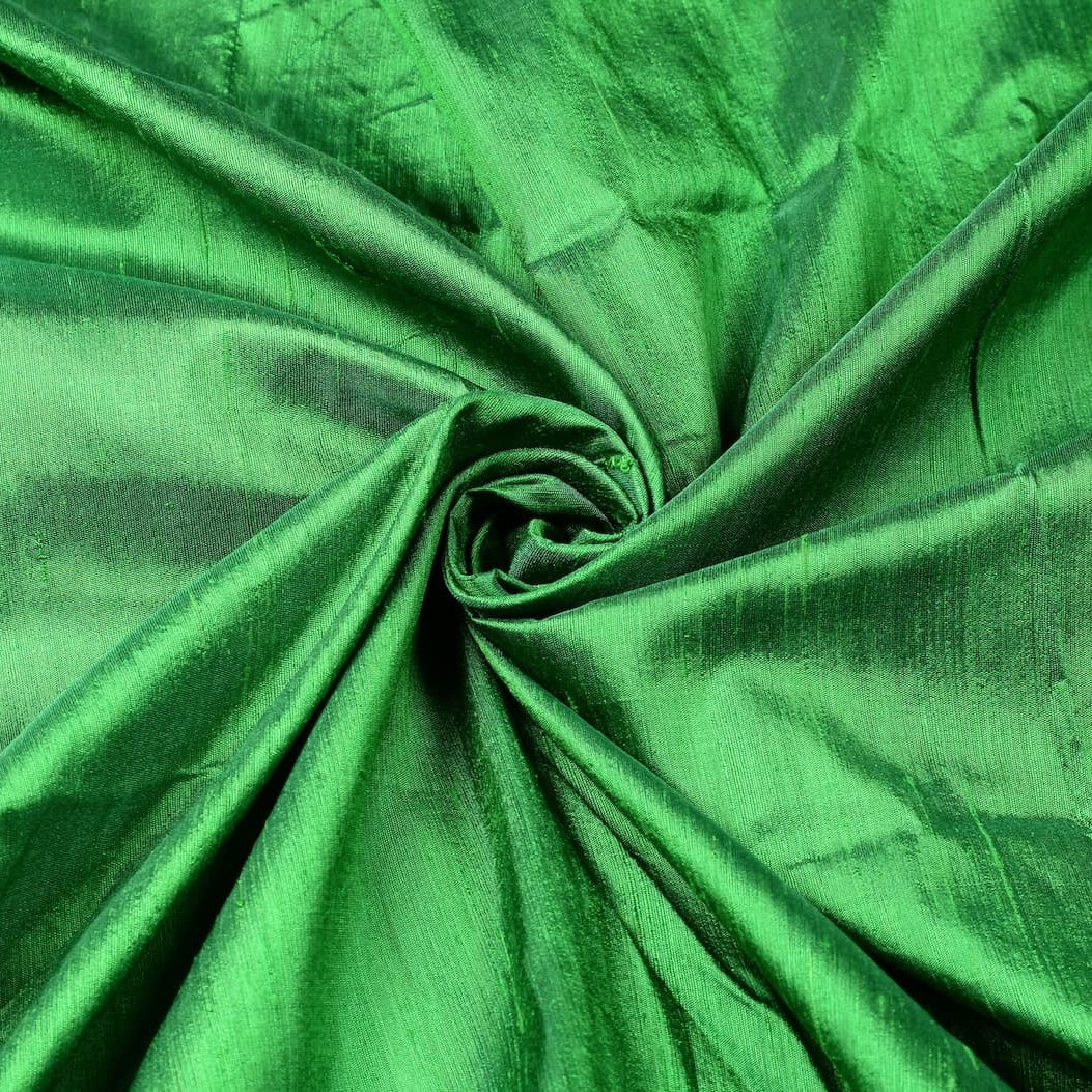 Spring Green Dupion Silk Fabric arranged in elegant swirling folds highlighting its lustrous sheen, crisp texture, and vibrant green tones