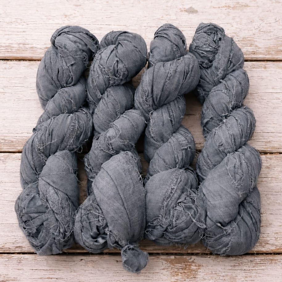 Bundle of storm grey sari silk ribbon skeins crafted from recycled sari silk.