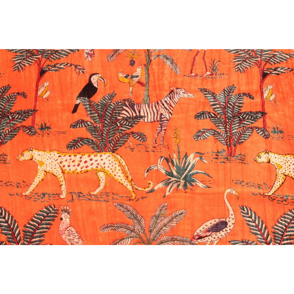 Close-up of exotic animal and foliage print on orange hand-printed velvet