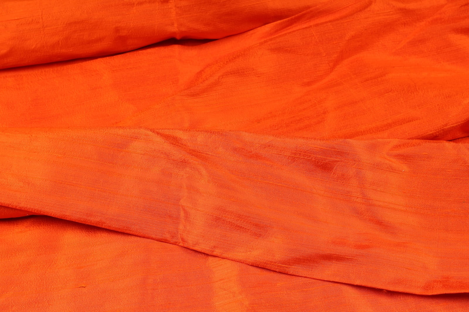 Orange Dupion Silk Fabric draped to show texture and lustre