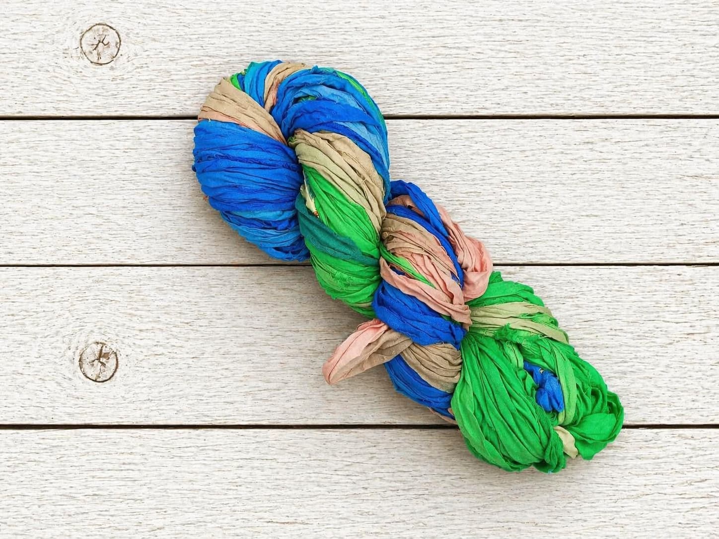 Single skein of Seaside Garden recycled sari silk ribbon yarn for weaving and crochet