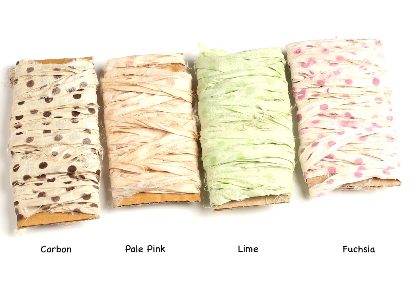 Polka dot sari silk ribbons in carbon, pink, fuchsia, and lime green shades on display