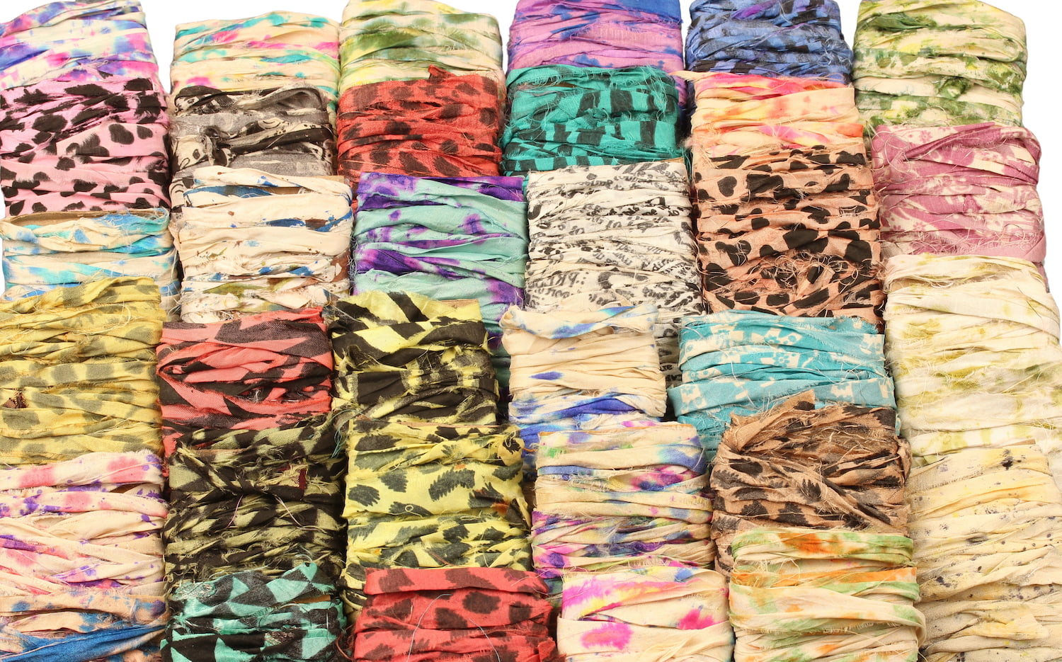 Assorted specialty sari silk ribbons in tie-dye and block print, 34 shades displayed on cardboard
