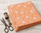Apricot block printed cotton fabric folded for sewing and quilting projects