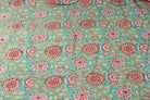 Aqua Chrysanthemum Garden hand block printed cotton fabric featuring red and ivory chrysanthemum flowers on an aqua background