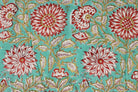 Close-up of Aqua Chrysanthemum Garden block printed cotton fabric showing chrysanthemum flowers and leafy vine details