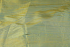 Close-up of Aqua Gold Dupion Silk Fabric showing natural slub texture, woven silk detail, and shimmering aqua-blue and gold tones