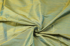 Aqua Gold Dupion Silk Fabric arranged in elegant swirling folds highlighting its luminous sheen, natural slub texture, and shimmering aqua-gold tones