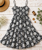 Black and white floral block printed cotton fabric shown as a dressmaking project