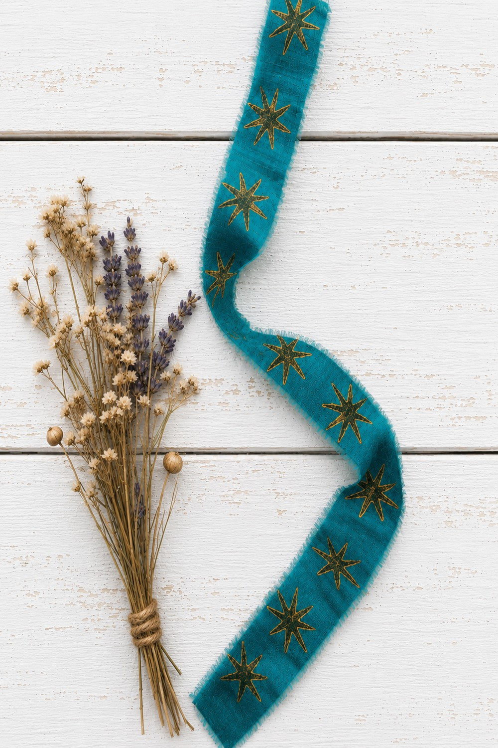 Teal block printed sari silk ribbon with gold star motif styled with dried flowers