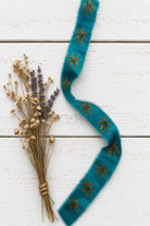 Teal block printed sari silk ribbon with gold star motif styled with dried flowers