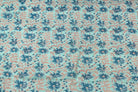 Aqua floral block print cotton fabric with repeating blue flowers, berries and leafy vine motifs