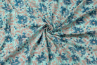 Hand block printed aqua cotton fabric draped to showcase blue floral pattern and soft fabric texture