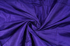 Blue Violet Dupion Silk Fabric arranged in elegant swirling folds highlighting its lustrous sheen, crisp texture, and rich jewel-toned colouring