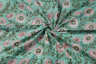 Hand block printed aqua cotton fabric draped to display floral chrysanthemum pattern and fabric texture
