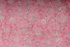 Close-up of Blush Marigold Sprig block printed cotton fabric showing delicate ivory floral motifs and trailing botanical stems