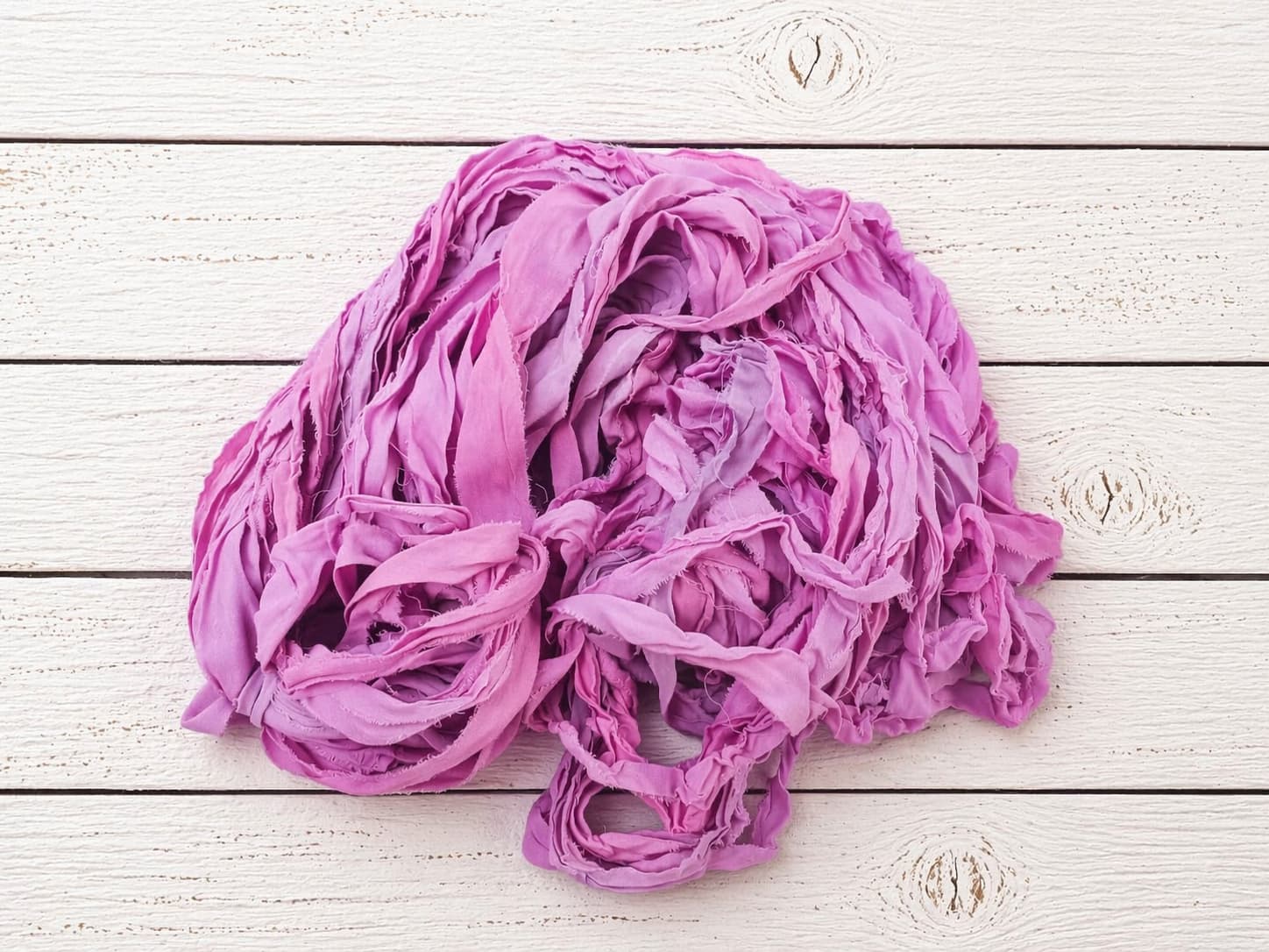Orchid Blossom chiffon silk ribbon yarn in orchid pink and lilac tones arranged in loose coils