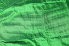 Spring Green Dupion Silk Fabric displayed with soft folds revealing natural silk texture, luminous sheen, and rich fresh green colouring