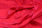 Electric Pink Dupion Silk Fabric displayed in flowing folds showing its vivid pink colour and luxurious silk finish