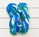 Two skeins of Ocean Breeze recycled silk ribbon yarn for weaving and crochet projects