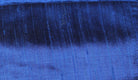 Close-up of Royal Blue Dupion Silk Fabric showing natural slub texture, woven silk detail, and vibrant sapphire-blue colour