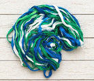 Coiled Ocean Breeze sari silk ribbon yarn showing vibrant ocean-inspired colors