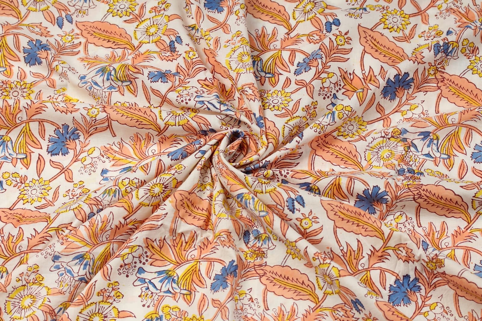 Close-up detail of Cornflower Daisy Trail block printed cotton fabric showing blue flowers and yellow daisies