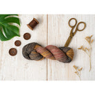 Hand-dyed Cotton Linen Yarn – Ember Night shade in black, red, and yellow tie-dye tones – styled image.