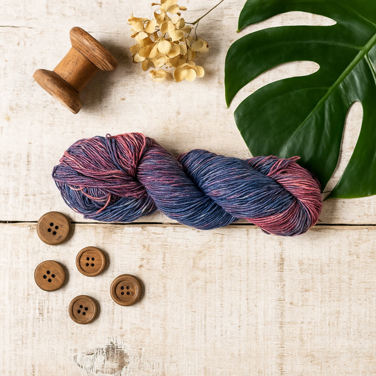 Hand-dyed Cotton Linen Yarn – Coral Tide shade in blue and red tones – styled image.