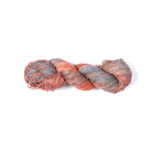 Hand-dyed Cotton Linen Yarn – Sky Drift shade in orange, light blue, white, and gray.