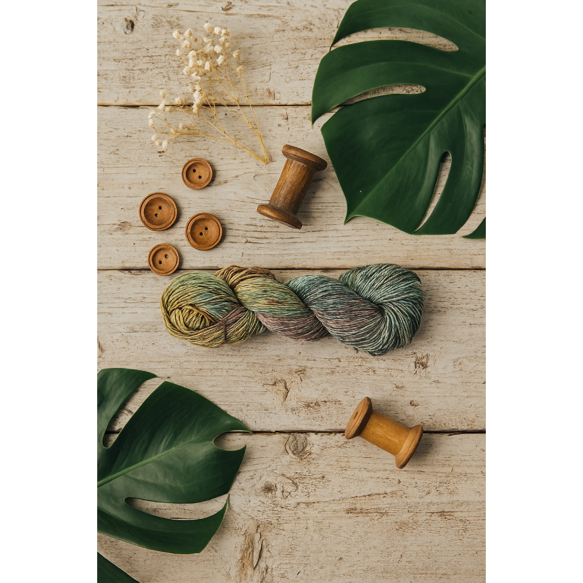 Hand-dyed Cotton Linen Yarn – Spring Ember shade in yellow, green, and red with slight white tones – styled image.