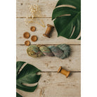 Hand-dyed Cotton Linen Yarn – Spring Ember shade in yellow, green, and red with slight white tones – styled image.