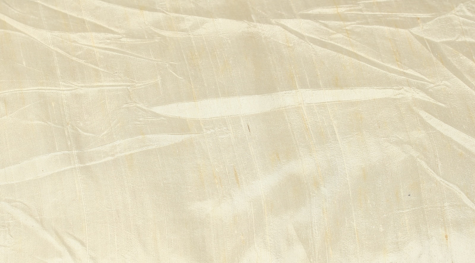 Close-up of Ivory Dupion Silk Fabric showing natural slub texture, woven silk detail, and soft ivory colour