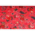 Deep red cotton velvet with hand-printed orange and blue flowers – flatlay