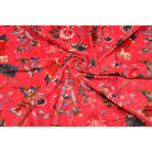 Folded red velvet showing soft texture and rich floral design