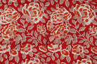 Close-up of Crimson Rosewood block printed cotton fabric showing hand-printed rose motifs and delicate foliage details