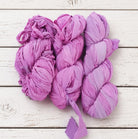 Multiple skeins of Orchid Blossom chiffon silk ribbon yarn in soft pink and mauve shades